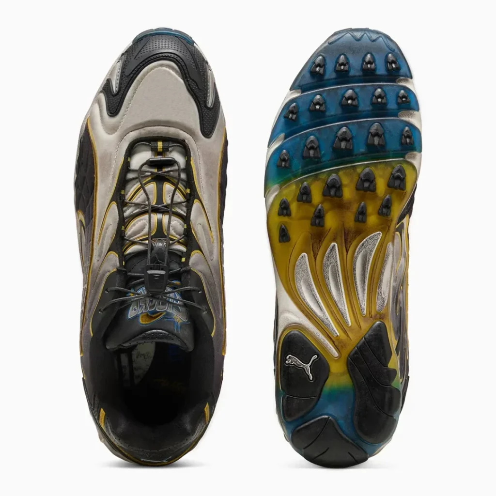 A top and outsole view displays the quick lace system, padded tongue with graphic branding, and a multicolored translucent rubber outsole featuring black traction lugs and a PUMA logo at the heel
