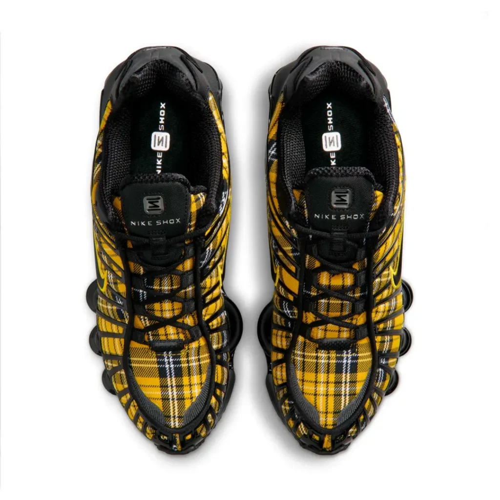 Top-down view of the Nike Shox sneakers displaying the tartan plaid textile uppers, black laces, padded collars, and Nike Shox-branded insole