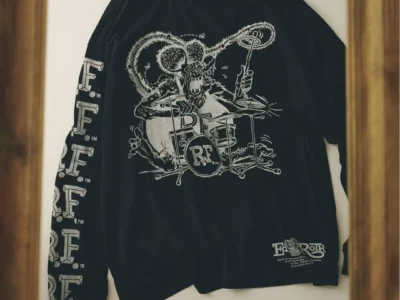 Black long sleeve Tee on display, screen printed with Ed "Big Daddy" Roth's Rat Fink character playing drums, repeating "R.F." lettering down the sleeve, and an "Ed Roth" logo lockup near the hem