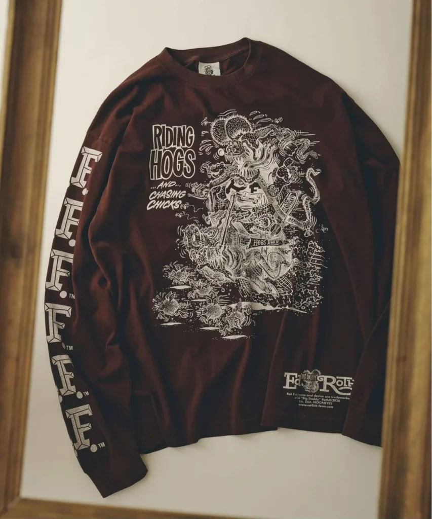 Maroon long sleeve Tee on display, screen printed with a Rat Fink motorcycle graphic, "Riding Hogs...and...Chasing Chicks" text, a "Hogs Rule" banner, repeating "R.F." lettering down the sleeve, and an "Ed Big Daddy Roth" logo near the hem