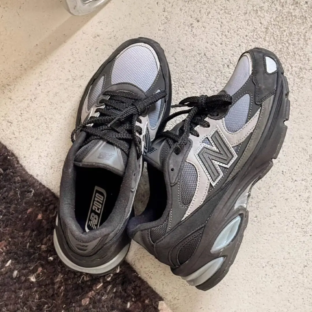 New Balance U2010 'Black/Harbor Grey' sneakers featuring black suede overlays, grey mesh panels, reflective details, oversized N logos, and sculpted ABZORB cushioning.