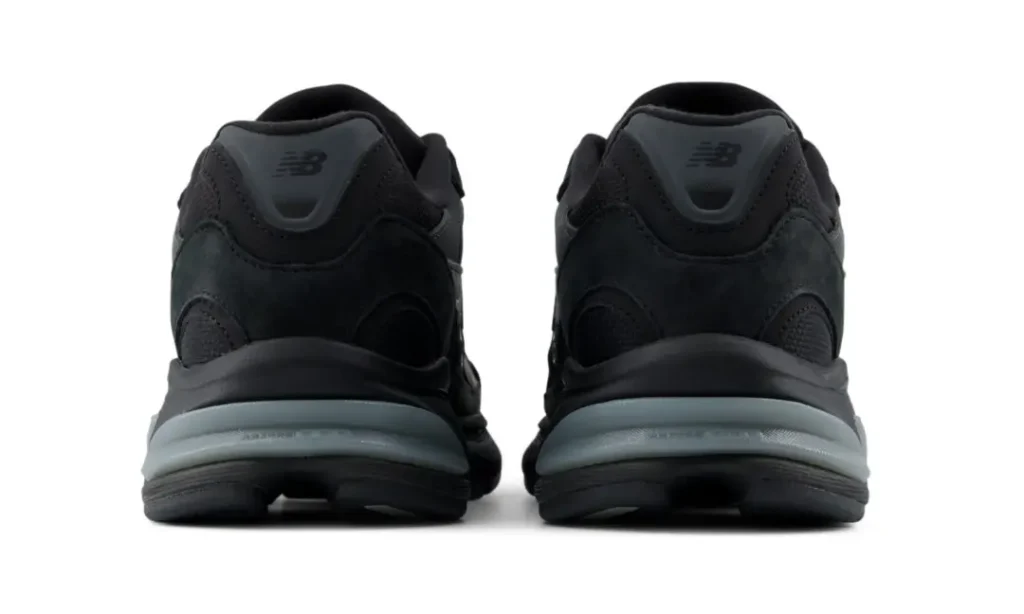 Rear view of the New Balance U2010 "Black/Harbor Grey" showcasing the padded heel, layered suede construction, and Harbor Grey heel cushioning integrated into the ABZORB mid