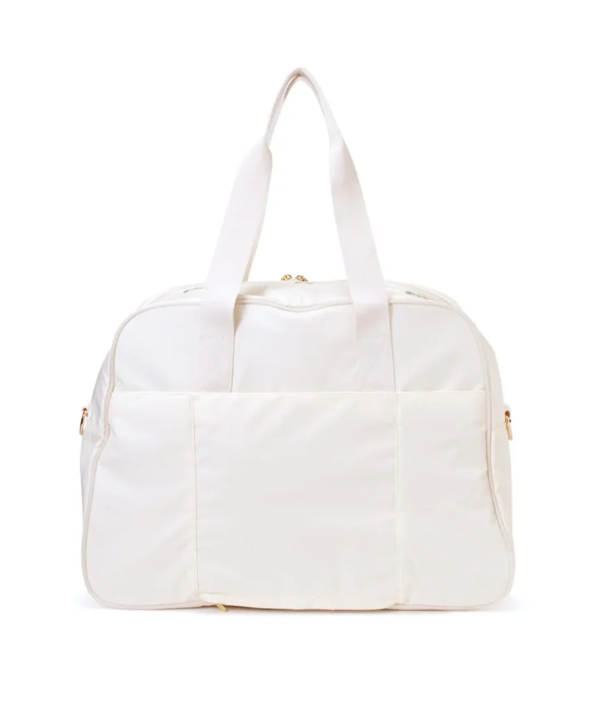 White LeSportsac travel duffel isolated against a white background, featuring multiple exterior pockets, gold hardware, and soft structured design