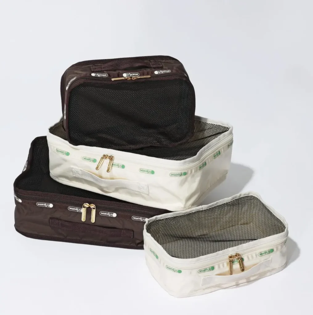 Coordinated LeSportsac packing cube collection in white and brown finishes with mesh tops and gold zipper pulls for organized lug