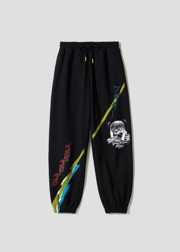 Black jogger sweatpants with colorful manga graphics, Japanese lettering, diagonal stripe artwork, and Kitarō character illustration