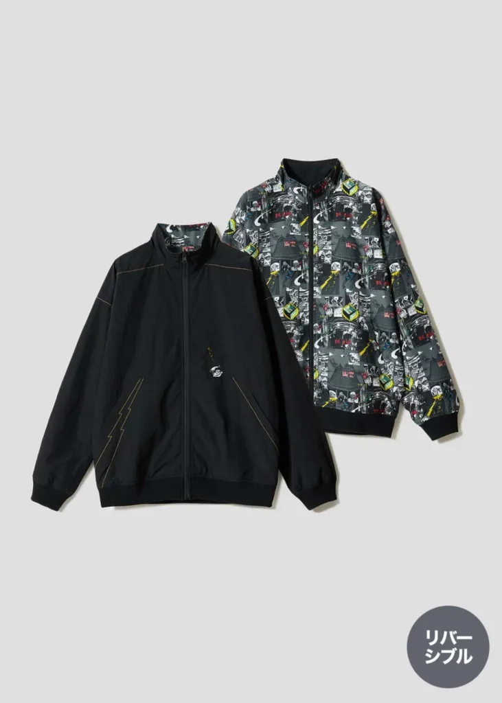 Reversible zip-up jacket shown with a minimalist black exterior and a fully printed interior featuring an all-over GeGeGe no Kitarō comic-inspired pattern