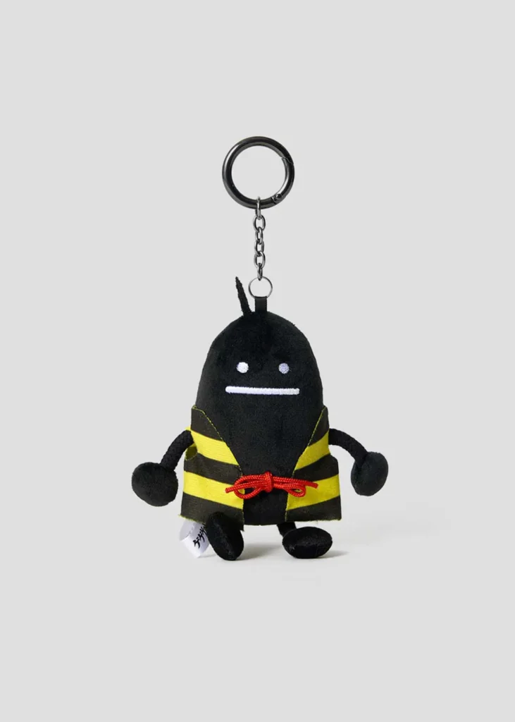 Black plush mascot keychain wearing Kitarō's signature yellow-and-black striped vest with a red cord belt, attached to a black metal key ring