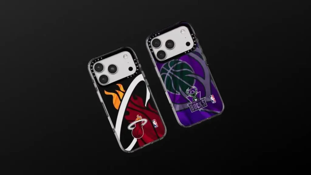 Two iPhone cases on a black background: left case has a Miami Heat flame-and-logo graphic in red and orange, right case has a Milwaukee Bucks basketball graphic in purple and green with the team's deer-head logo