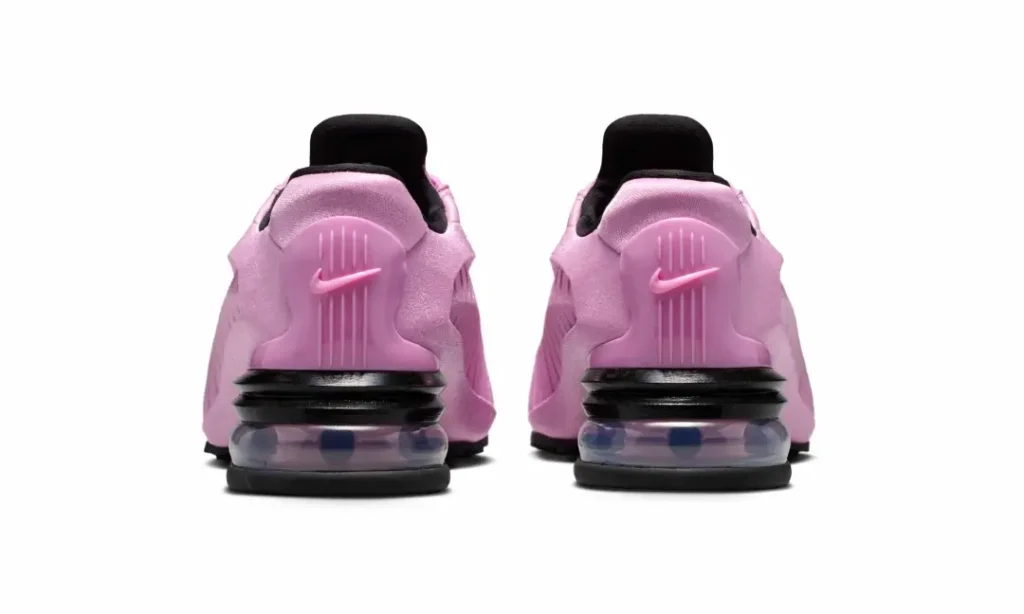 Rear view of the pair featuring molded pink heel counters with embossed Nike Swooshes, black heel support frame, and transparent Air Max cushion unit