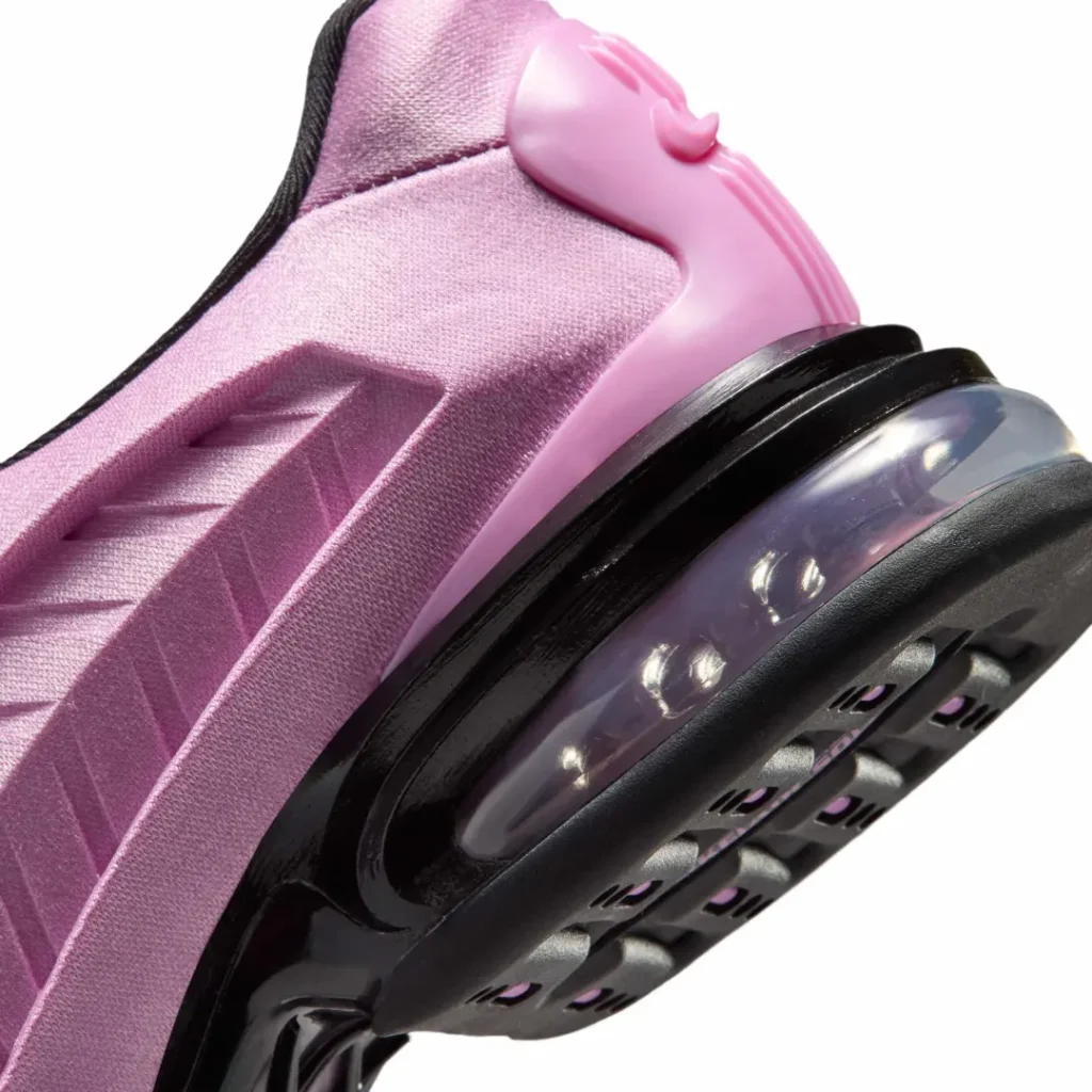 Macro detail of the heel highlighting the glossy black Air Max carrier, transparent visible Air unit, textured pink upper, and sculpted heel support