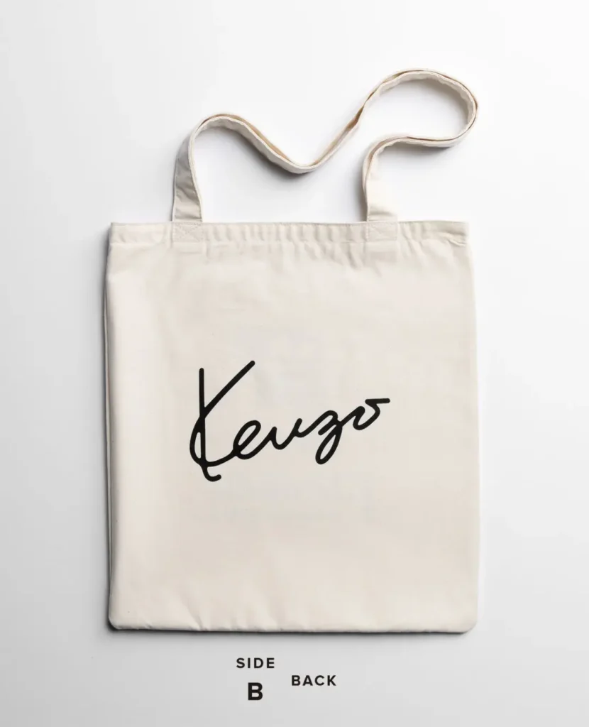 Minimal natural canvas tote bag featuring a large black Kenzo signature logo centered on the back with long carrying handle