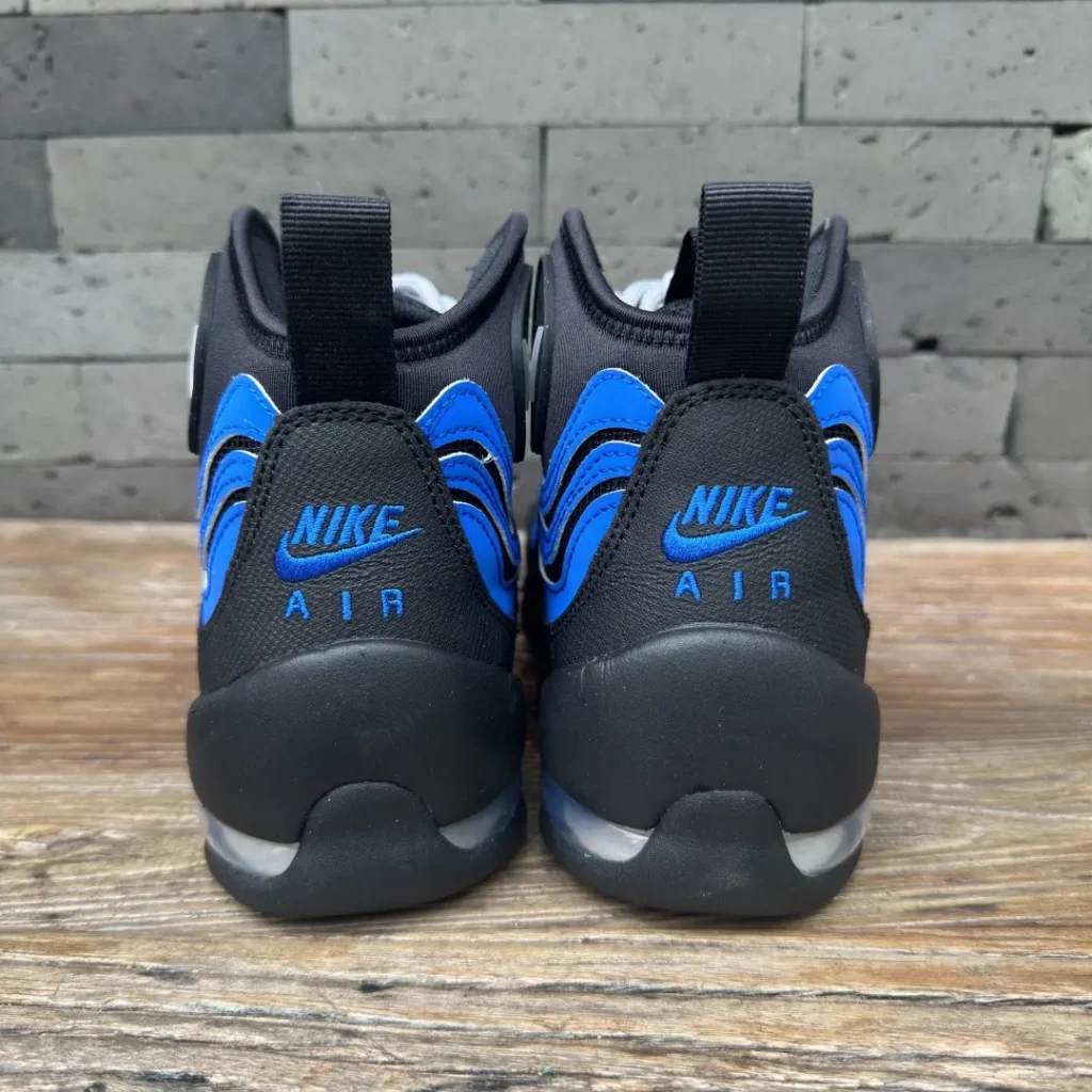 Rear view of the Nike Air Bakin showing embroidered Nike Air heel branding, black pull tabs, royal blue accents, and exposed heel Air unit