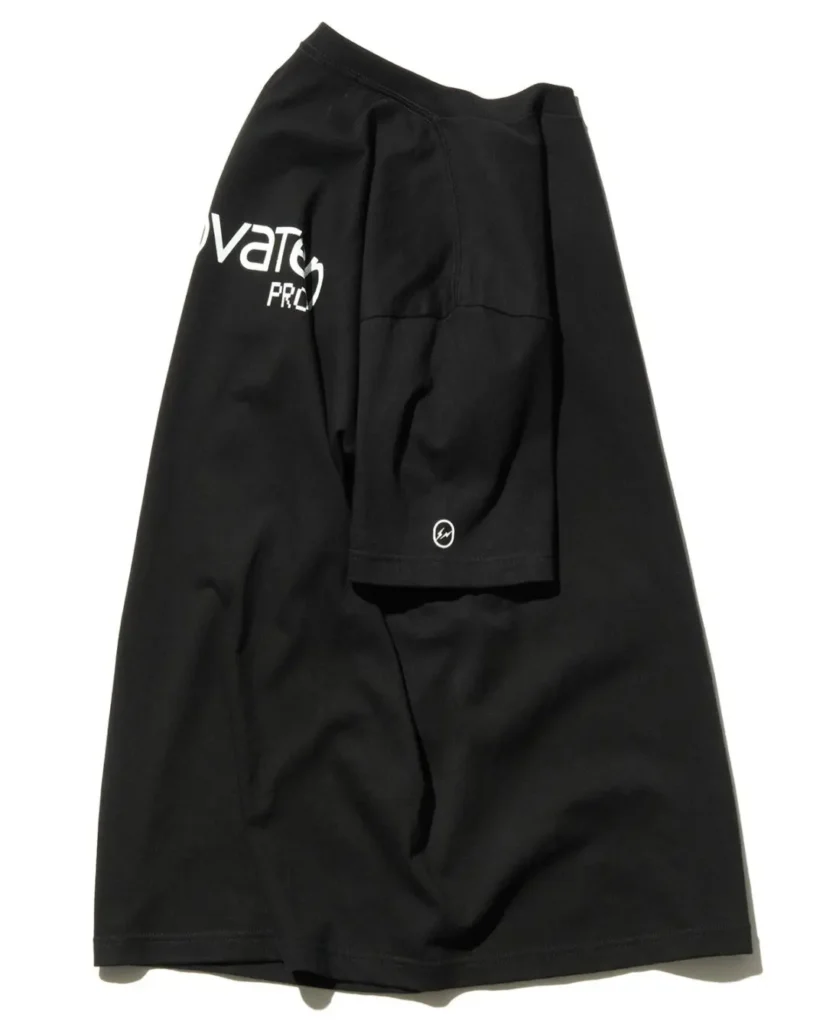 Black collide Tee draped to highlight the oversized back "innovaten PROOF" graphic and white Fragment Design sleeve logo