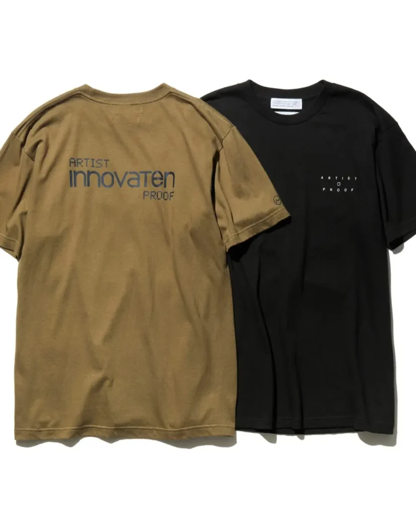 Two collision Tee displayed side by side: an olive green version with oversized back brand and a black version with minimalist front "ARTIST PROOF" chest print