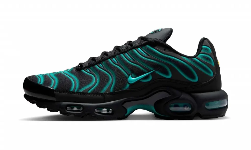 The lateral side of the Nike Air Max Plus showcases a black mesh upper accented by luminous teal wave overlays, a matching teal Swoosh, black midsole with visible Tuned Air units, and a glossy black toe cap against a white backdrop