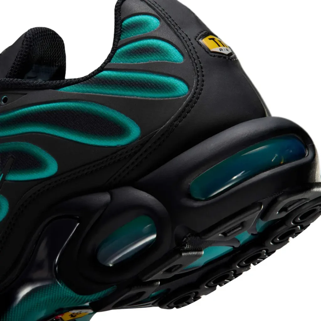 A macro view focuses on the sculpted black midsole and large teal-tinted Air Max heel unit, highlighting the Tuned Air cushion system, glossy molded support structure, and teal outsole extending beneath the shoe