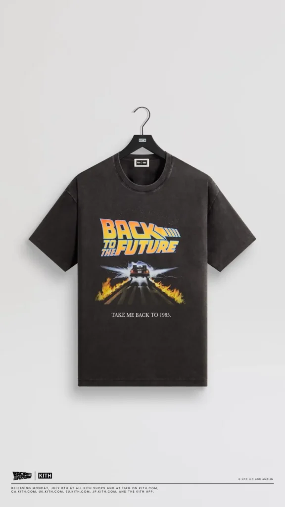 Vintage black Kith Tee featuring the Back to the Future logo above the DeLorean leaving flaming tire tracks with the phrase "Take Me Back to 1985."