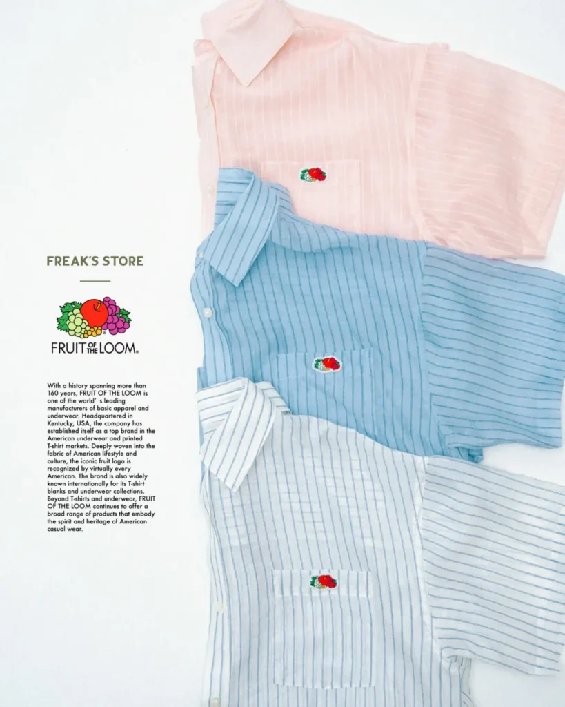 Three striped short-sleeve button-up shirts in white, blue, and pale pink from the FREAK'S STORE × Fruit of the Loom collection, each finished with the iconic embroidered fruit logo on the chest pocket