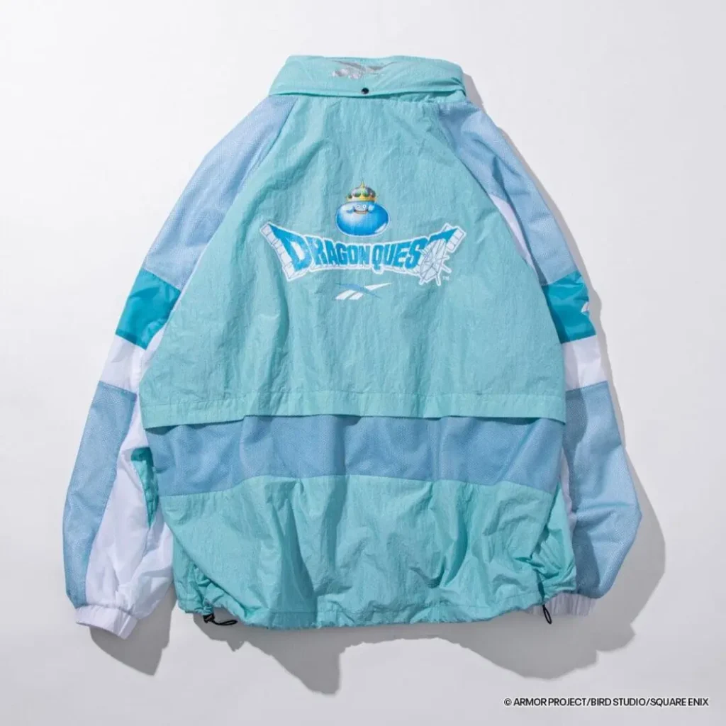 Rear view of the aqua jacket showcasing a large Dragon Quest logo topped by a blue Slime graphic, with mesh paneling and adjustable hem detail