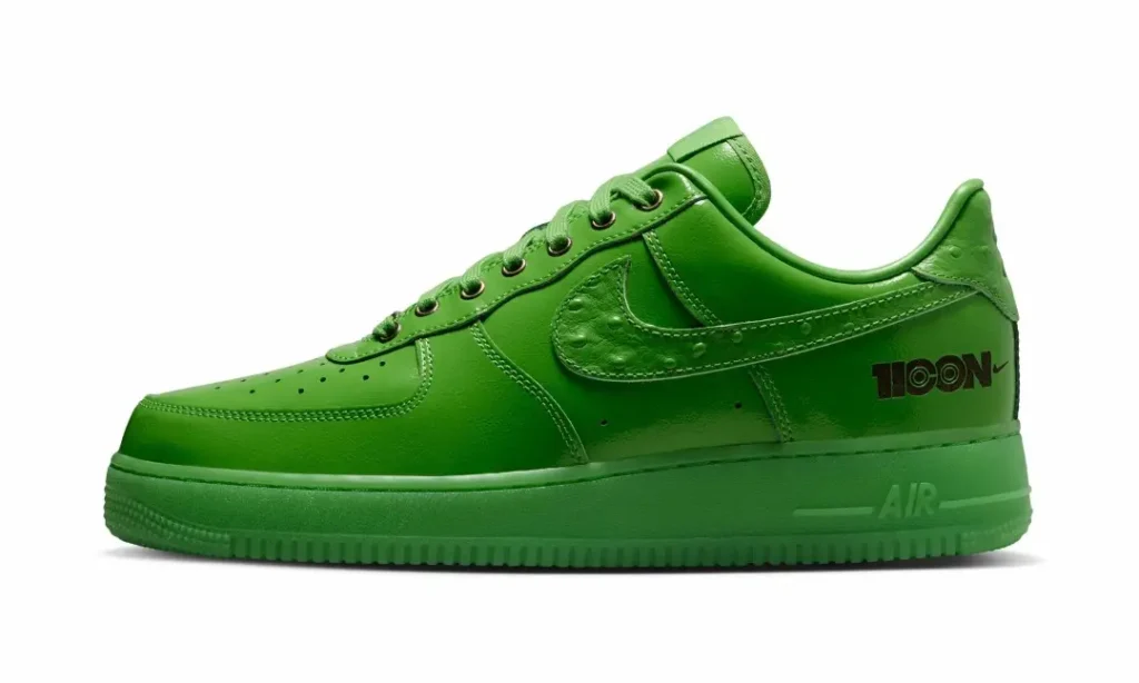 Lateral profile of the bright green Nike Air Force 1 Low showcasing monochromatic leather construction, ostrich-textured Swoosh, tonal sole unit, and black heel graphic brand