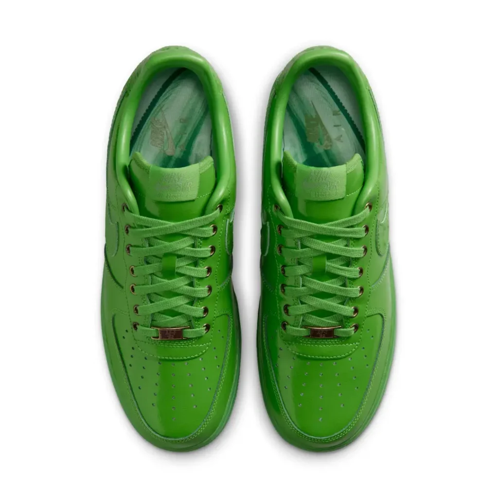 Top-down view of the bright green Nike Air Force 1 Low revealing tonal laces, perforated toe boxes, padded collars, and branded green insole