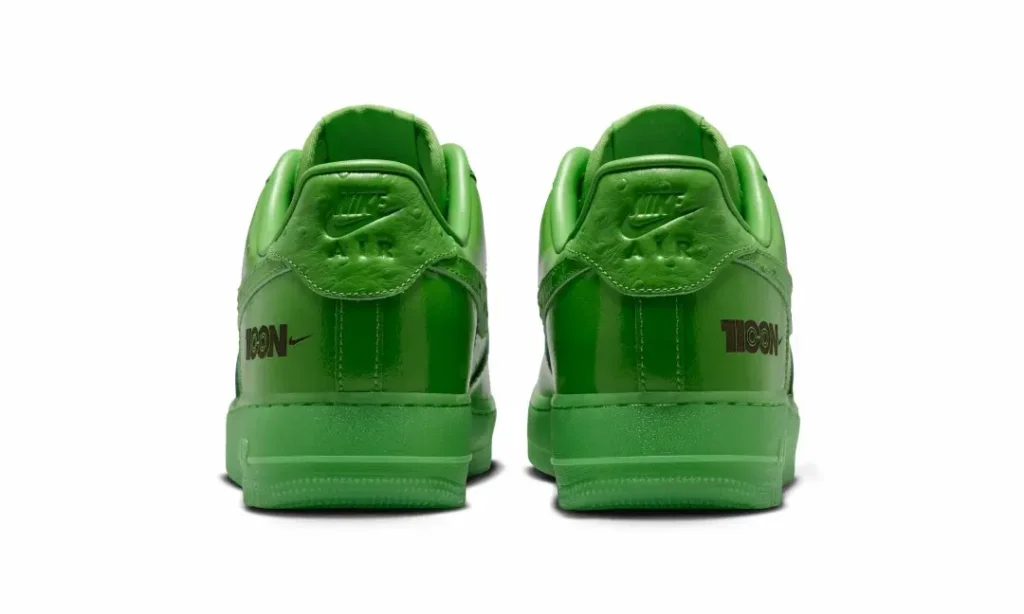 Rear view of the bright green Nike Air Force 1 Low featuring embossed Nike Air heel tabs, tonal midsoles, and black "1100N" branding on both heel