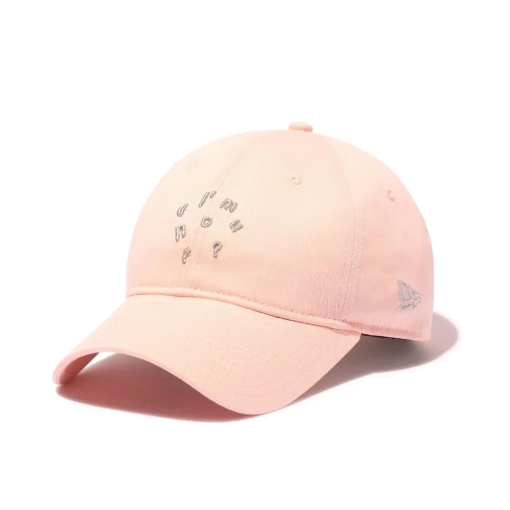 Pastel pink New Era "I'm Donut?" dad cap isolated on a white background, featuring silver embroidered typography on the crown, a curved visor, and a matching silver New Era side logo
