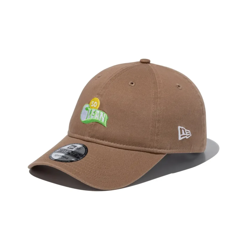 Tan adjustable curved brim cap featuring a colorful "SO CLEAN" embroidered logo on the front and white New Era side logo