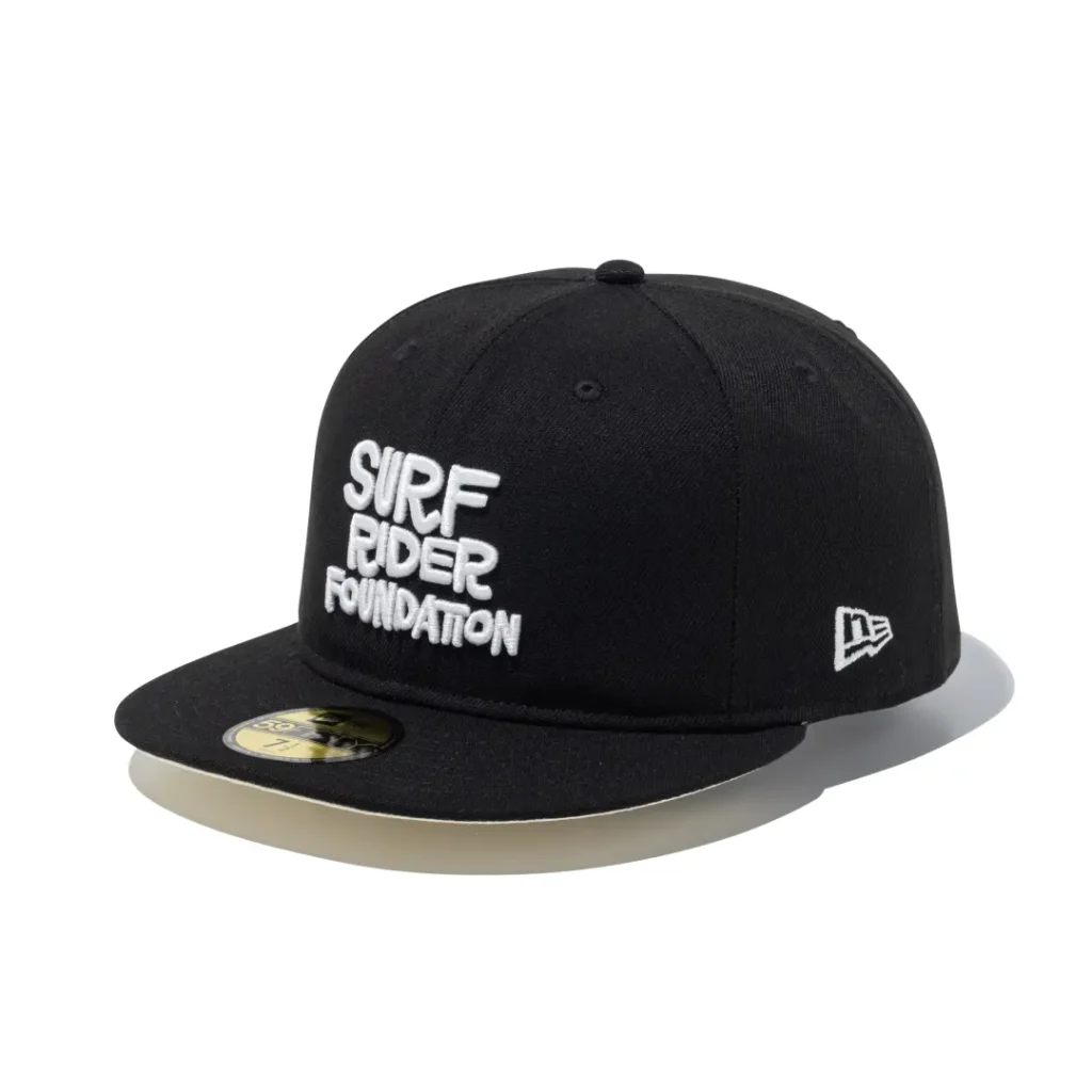 Black fitted flat brim cap with bold stacked white Surf Rider Foundation embroidery across the front crown