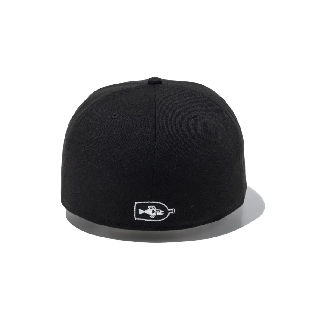 Back view of a black fitted cap with a small embroidered bottle containing a fish graphic centered above the rear seam