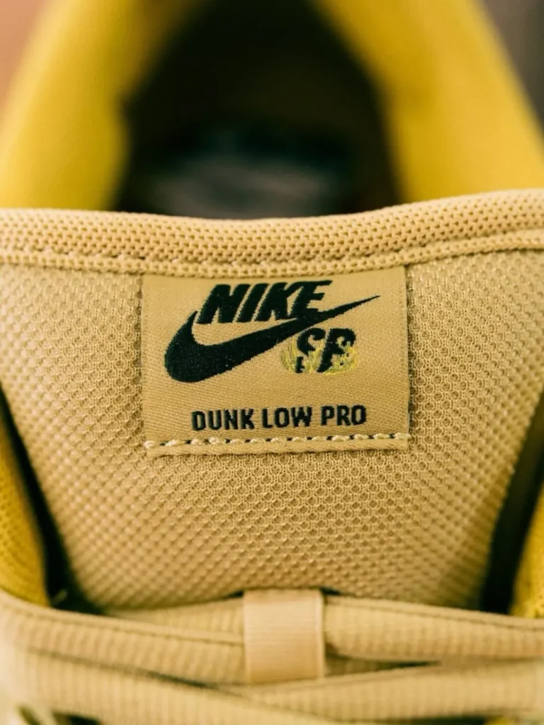 Close-up of the woven Nike SB Dunk Low Pro tongue label stitched onto a breathable cream mesh tongue