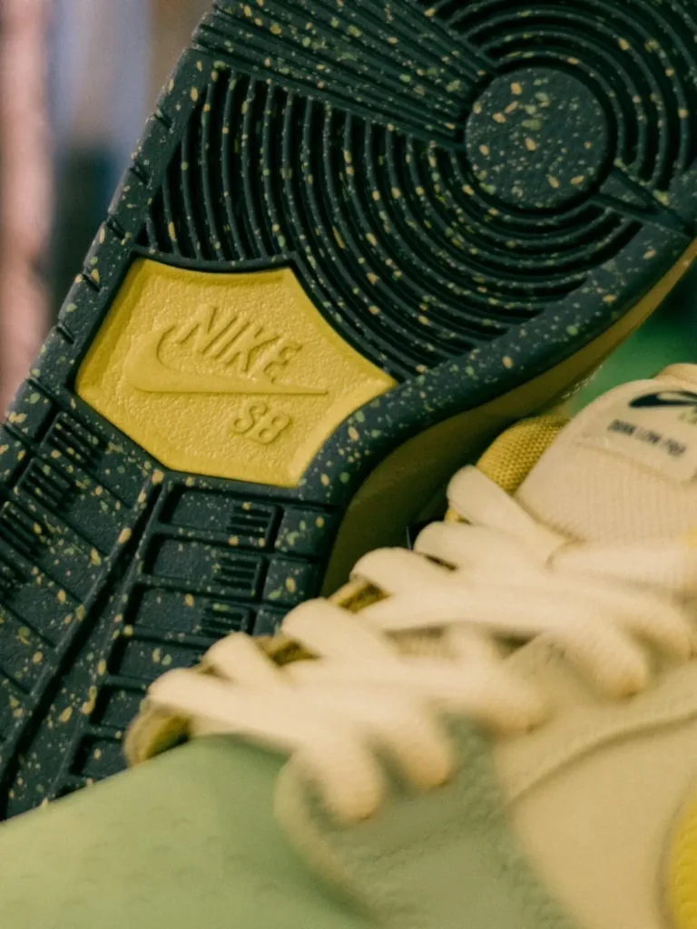 Detailed view of the Nike SB outsole featuring a black rubber tread with yellow speckling and an embossed Nike SB logo in the midfoo