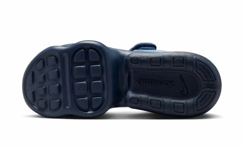 Bottom view of the Nike Air Max platform sandal displaying the outsole tread pattern. The navy rubber sole features segmented traction pods beneath the forefoot and heel, molded "AIR MAX" branding at the midfoot, and an embossed Nike Swoosh surrounded by durable grip zone