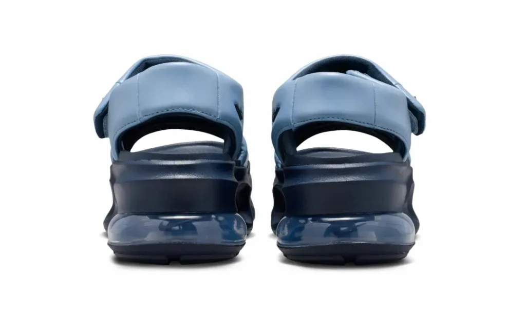 Rear view of the Nike Air Max platform sandals positioned side by side. The image focuses on the padded heel straps, elevated platform midsoles, and the transparent Air Max cushioning units extending across the back of each sandal, emphasizing stability and impact protection