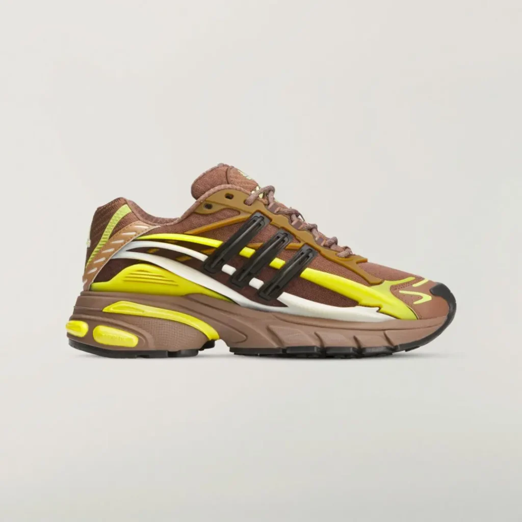 Side profile of the adidas x Ne.jelly Virginia sneaker featuring a brown mesh upper with neon yellow overlays, black Three Stripes cage, white sculpted side panels, and a chunky cushion