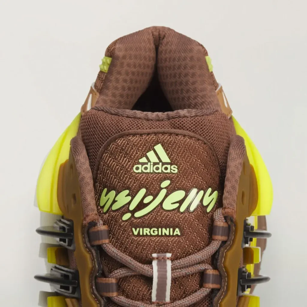 Close-up of the adidas x Ne.jelly Virginia tongue showing co-branded adidas and Ne.jelly Virginia logos, brown mesh construction, rope laces, and black Three Stripes support cage