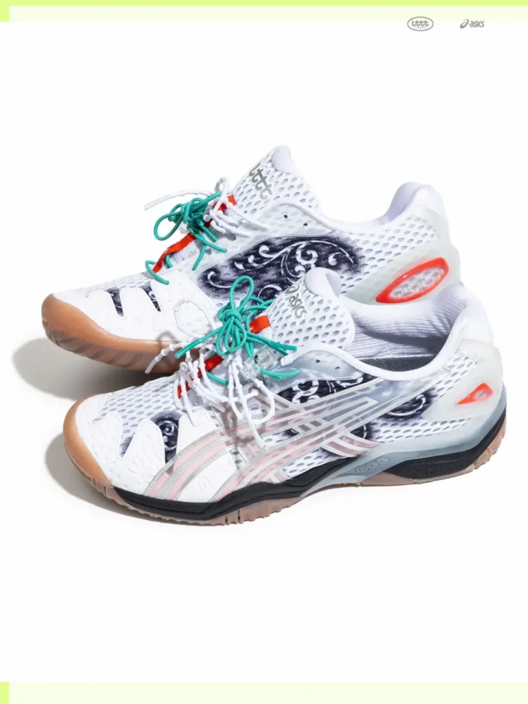 Studio product image of the white ASICS x Lttt table tennis shoe featuring translucent overlays, gum rubber outsole, black ornamental graphics, green secondary laces, and red heel accent