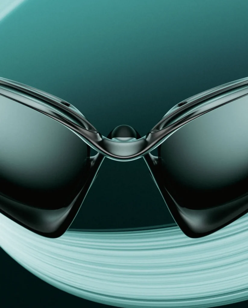 Close-up front view of Oakley Infiniloop sunglasses highlighting the sculpted bridge, glossy black frame, mirrored lenses, and aerodynamic design with soft teal light trail