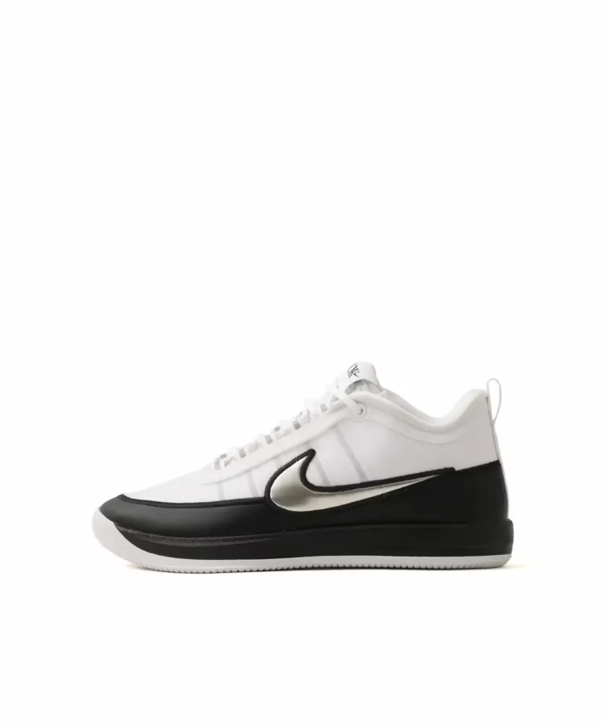 Lateral profile of the Nike BOOK Chapter Two shoe showcasing a white mesh upper, metallic silver Swoosh, black mudguard, and low-top sil