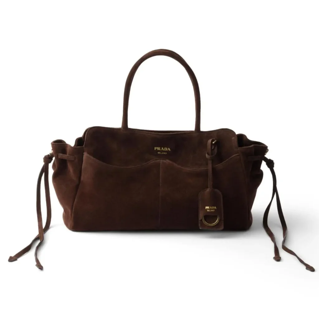 Dark chocolate brown suede Prada handbag with dual top handles, front patch pockets, side drawstrings, and a removable leather tag