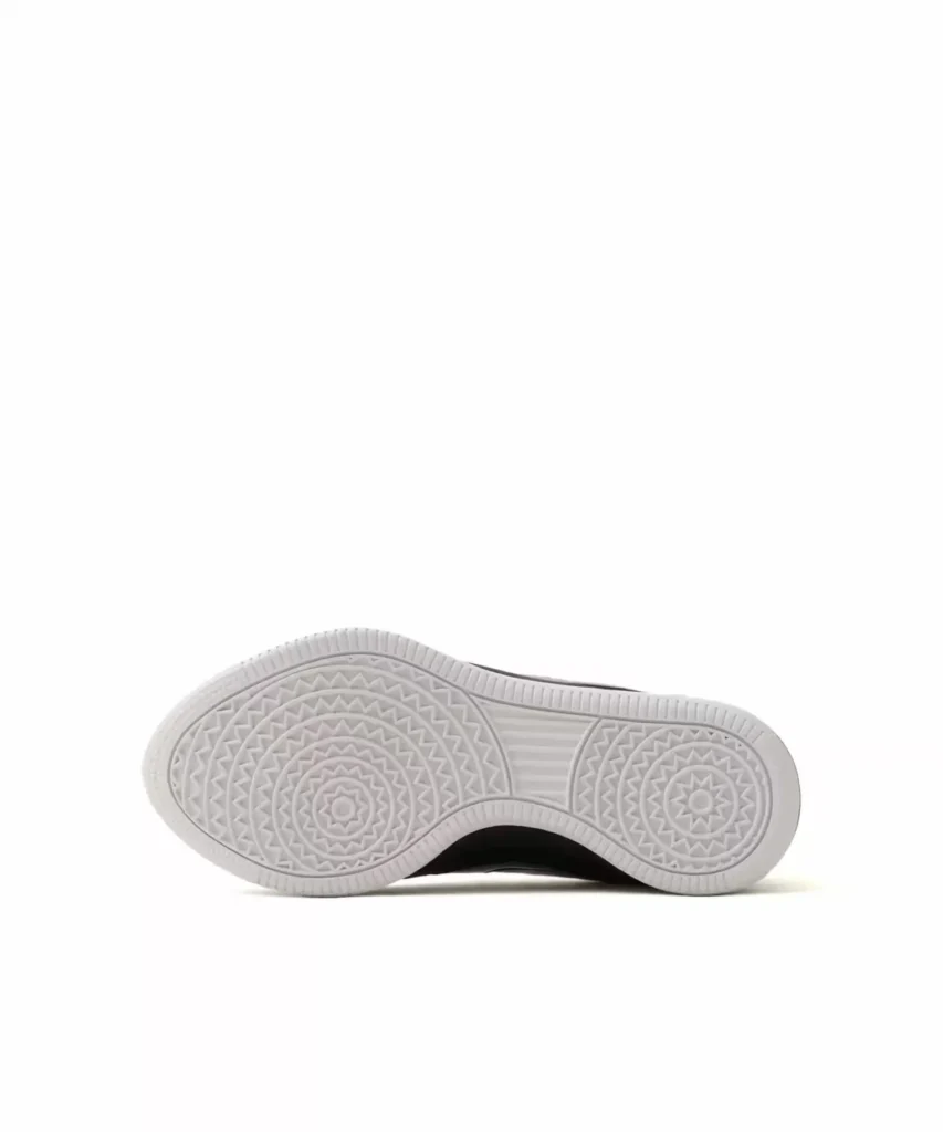 White rubber outsole featuring concentric circular traction patterns, herringbone detailing, and a pivot-point design for grip and stable