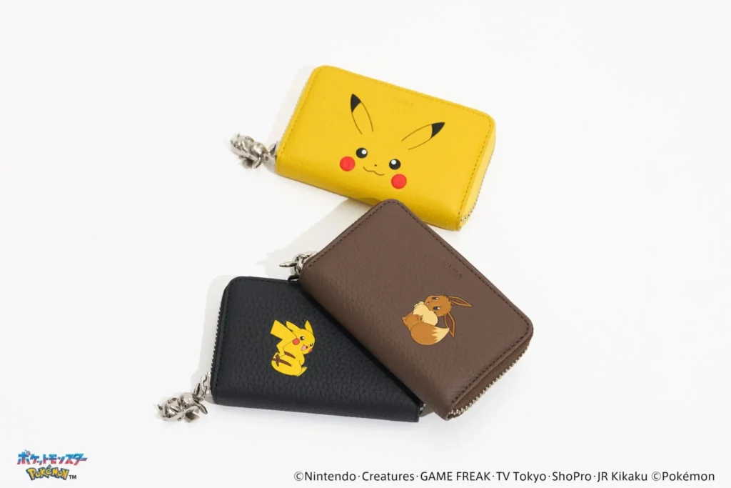 Three compact zip-around leather wallets featuring Pokémon designs, including a bright yellow Pikachu face wallet, a black wallet with Pikachu artwork, and a brown wallet with Eevee artwork, arranged on a white studio background