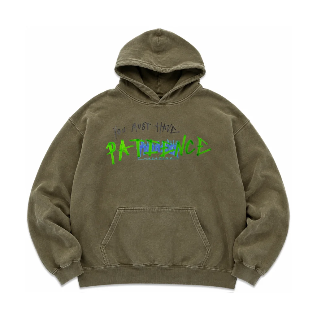 Vintage olive hoodie with a faded magazine-style chest graphic partially covered by a handwritten "You Must Have PATIENCE" design in black and neon green