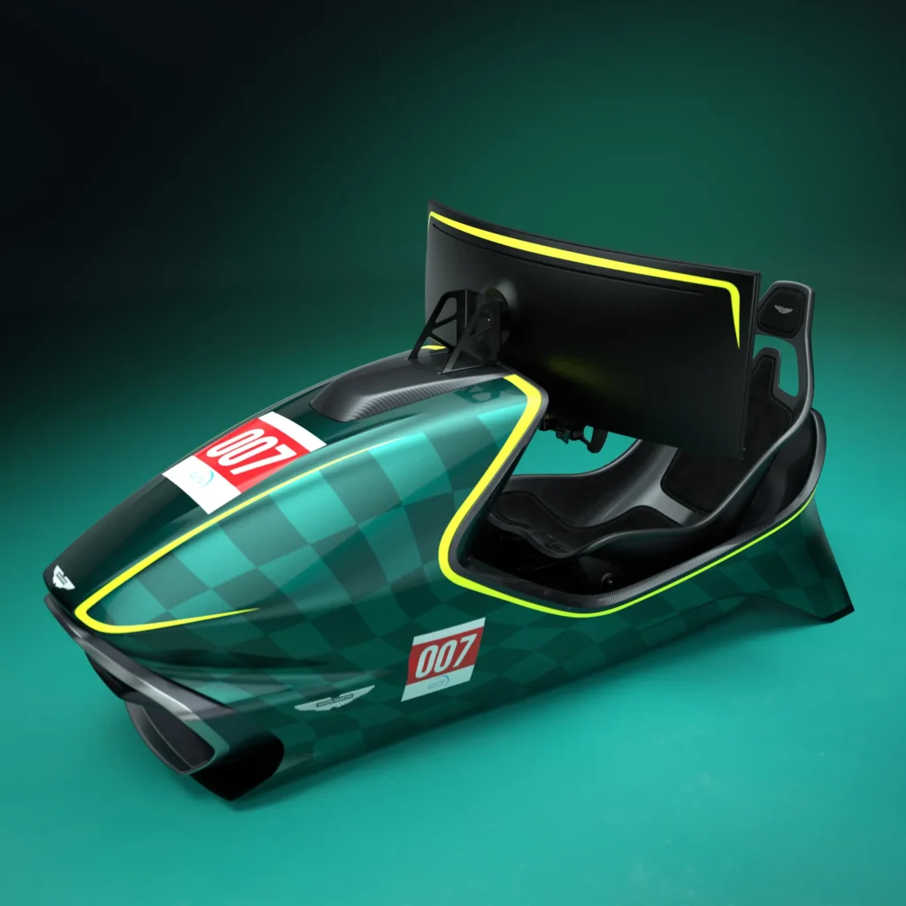 Front three-quarter view of an Aston Martin-inspired racing simulator featuring a streamlined British racing green shell, yellow accent trim, integrated bucket seat, carbon-fiber-style details, and a curved ultrawide monitor mounted behind the cockpit