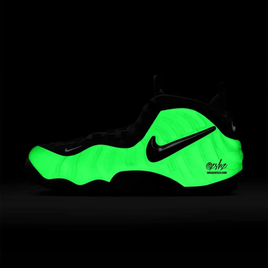 Nike Air Foamposite shoe glowing bright neon green against a dark background. The luminous effect highlights the wavy sole and black upper in a dramatic, eye-catching present