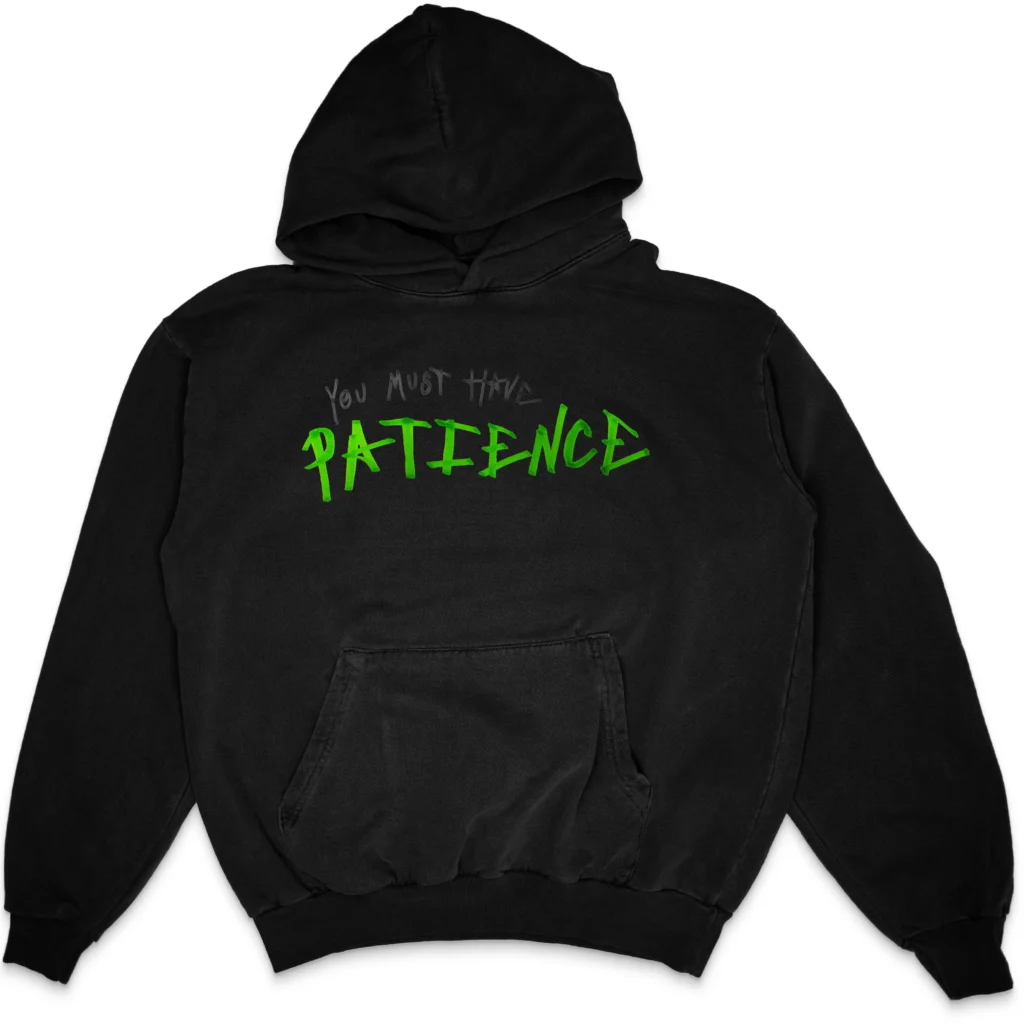 Black pullover hoodie with a minimalist handwritten "You Must Have PATIENCE" graphic in charcoal and bright green centered across the chest