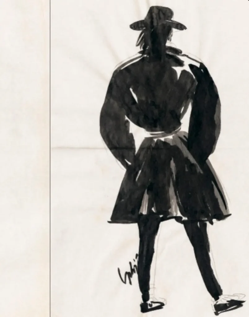 Bold black ink fashion show of a figure from behind wearing a wide-brim hat, voluminous jacket, and flared skirt, drawn with dramatic brushwork