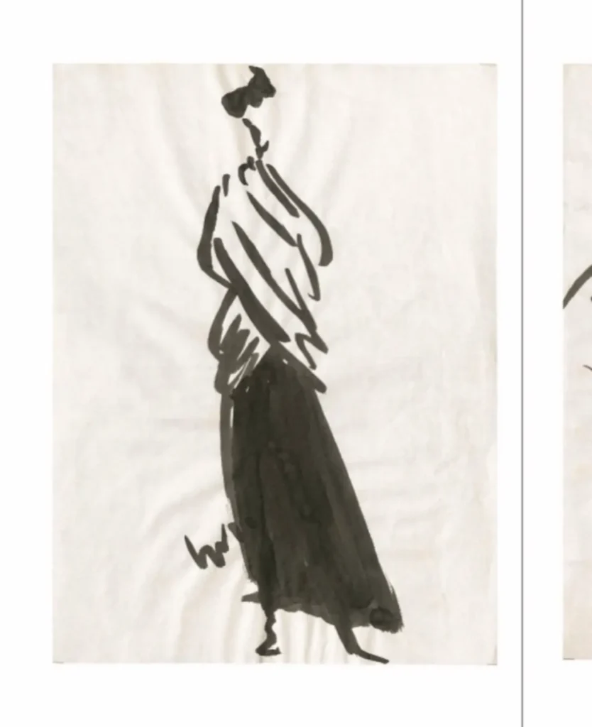 Min black ink fashion sketch of a slender figure in a flowing long skirt and loose top, drawn with broad gestural brushstroke