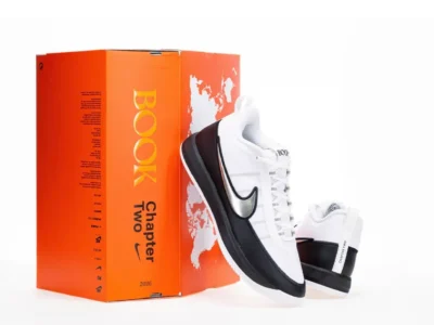 Nike BOOK Chapter Two sneakers posed beside the collectible orange "BOOK Chapter Two" shoebox, emphasizing premium packaging and signature brand