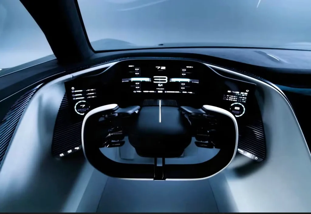 Driver's-eye view of the Lexus Electrified Sport concept cockpit featuring a yoke-style steering wheel, wraparound digital instrument display, minimalist dashboard, and illuminated performance gauges in a futuristic black-and-white interior